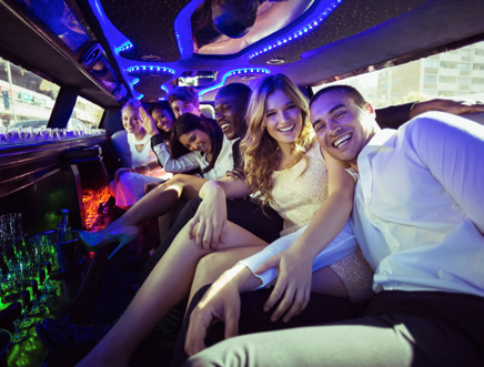 A group of people sitting in the back of a limo.