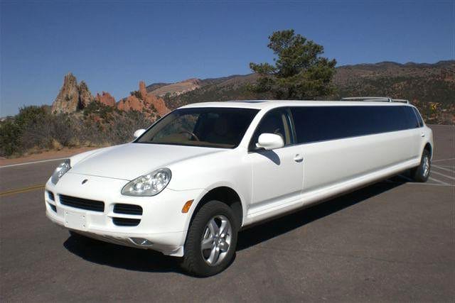 A white car parked on the side of road.