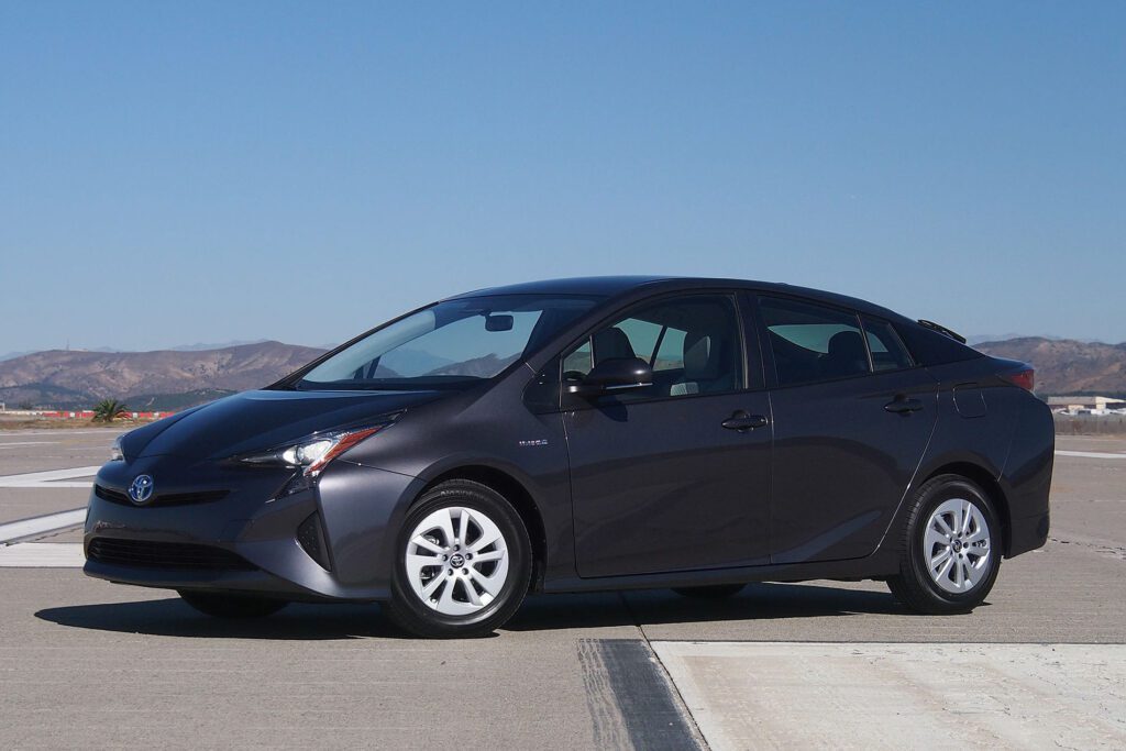 A gray car parked on the side of a road.