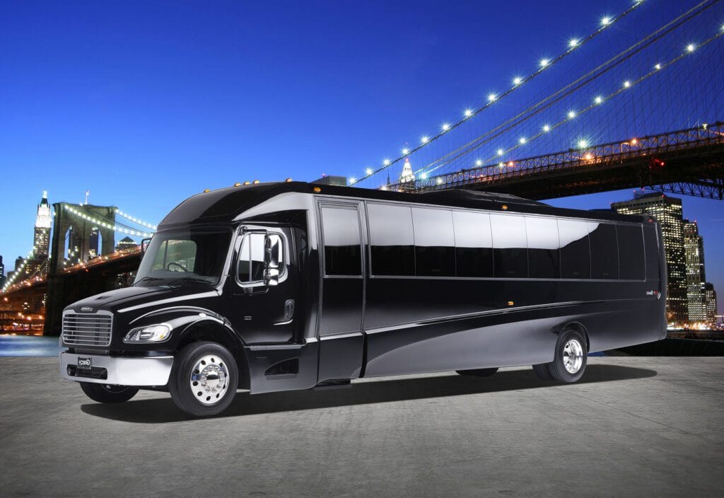 A black and silver bus is parked in the street