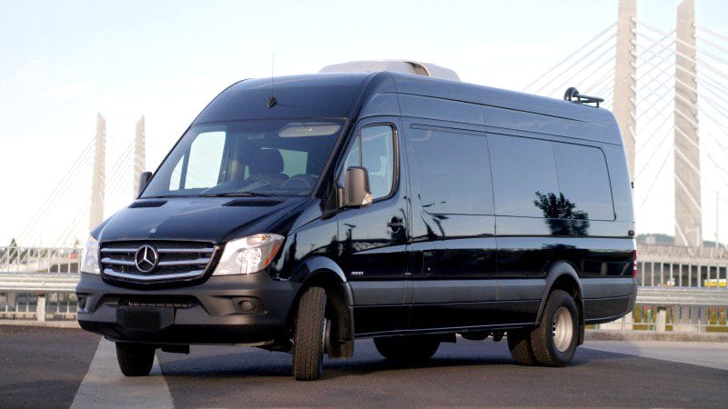 A black van is parked in the parking lot.