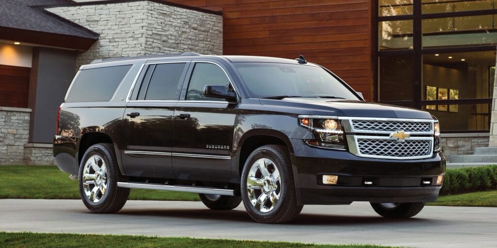 A black suv parked in front of a building.