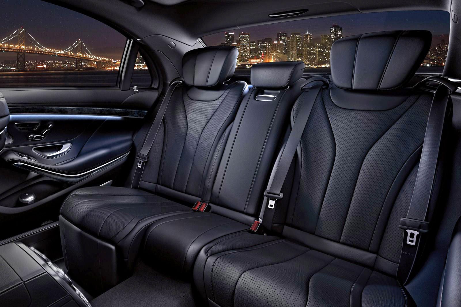 A car with black leather seats and the back seat folded down.