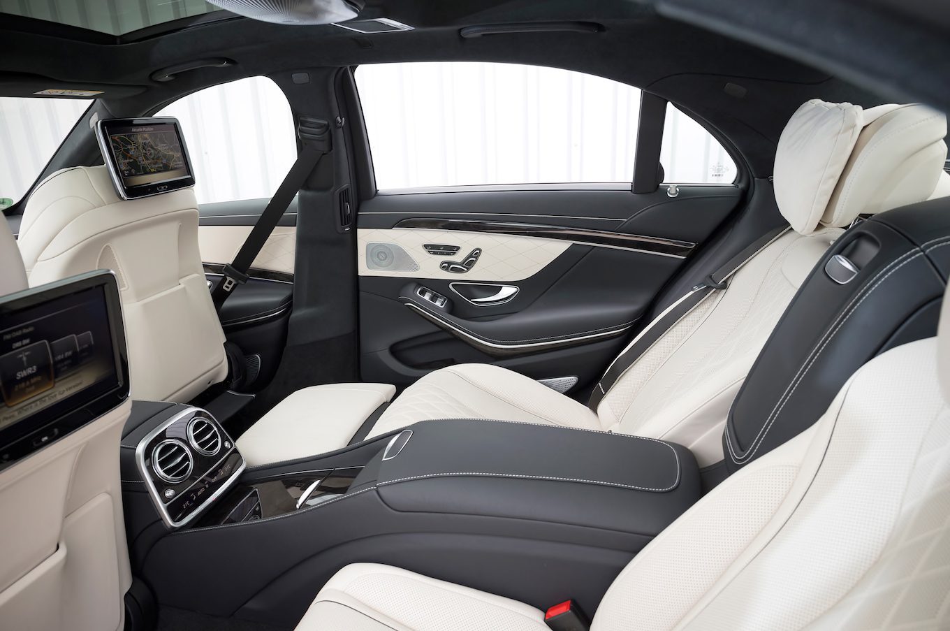 A car with white leather seats and black trim.