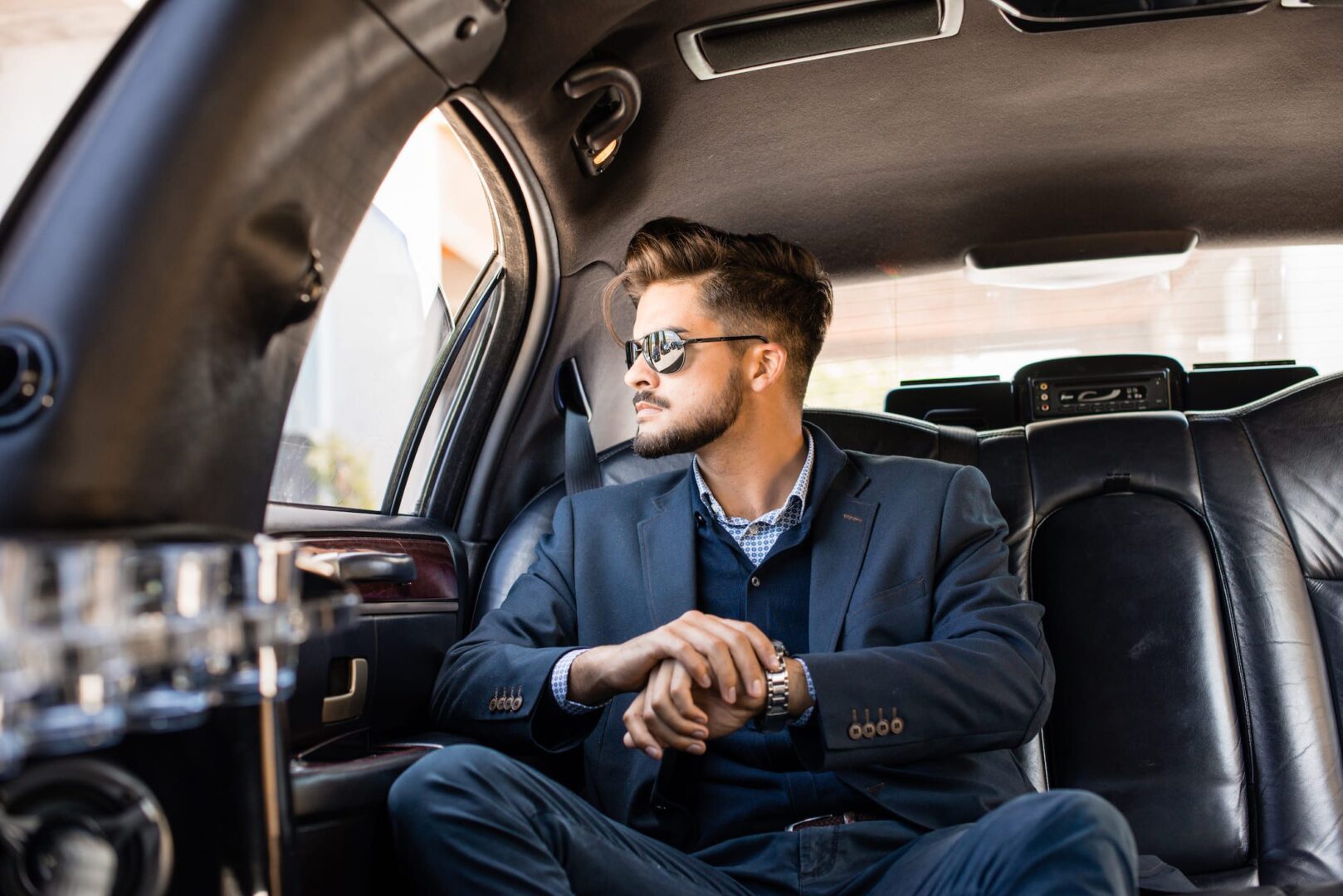 A man sitting in the back of a car.