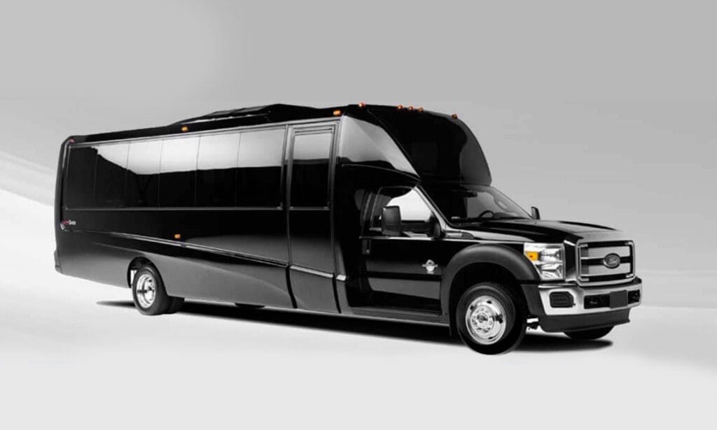 A black limo bus is parked in front of the camera.