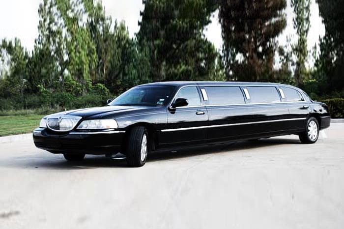 A black limo is parked in the parking lot.