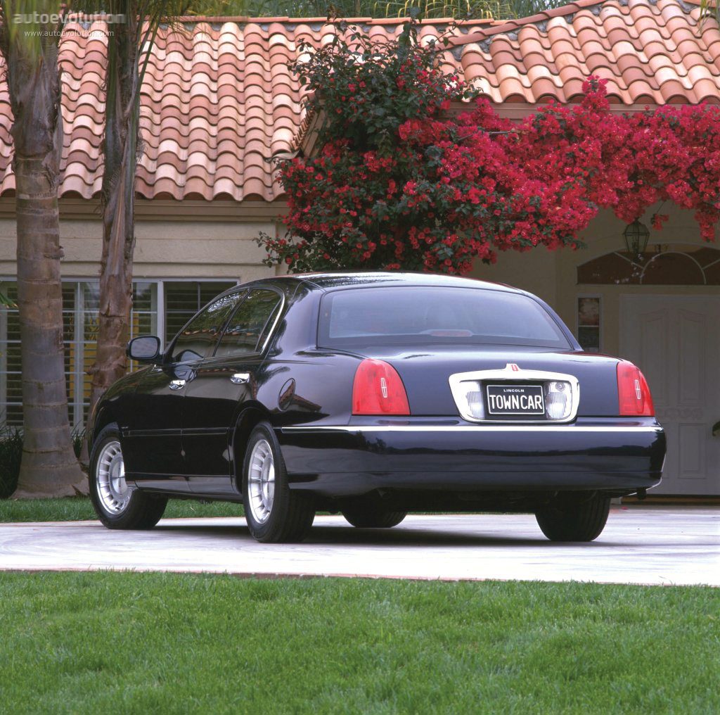 A black car parked in front of a house.