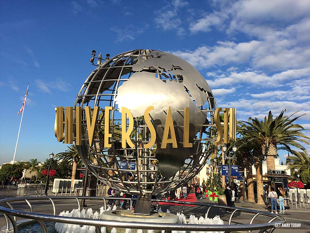 A large metal globe with the word universal on it.