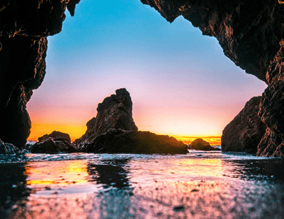 A view of the ocean from inside an arch.