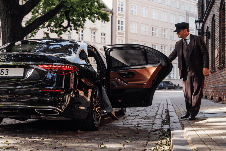 A man standing next to an open car door.