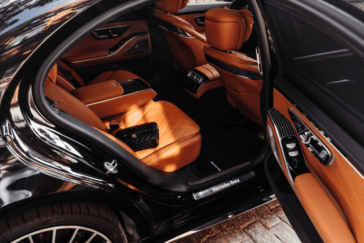 A car with orange leather seats and black trim.