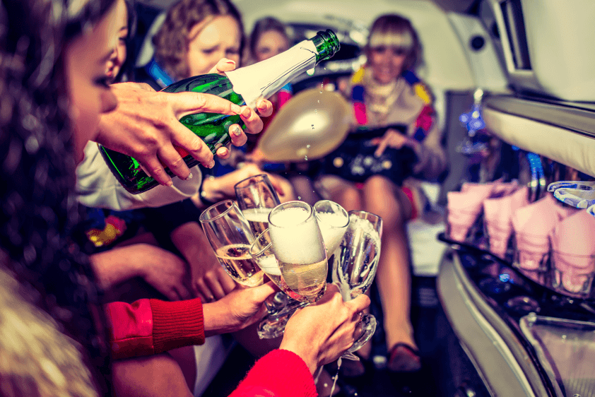 A group of people sitting around drinking champagne.