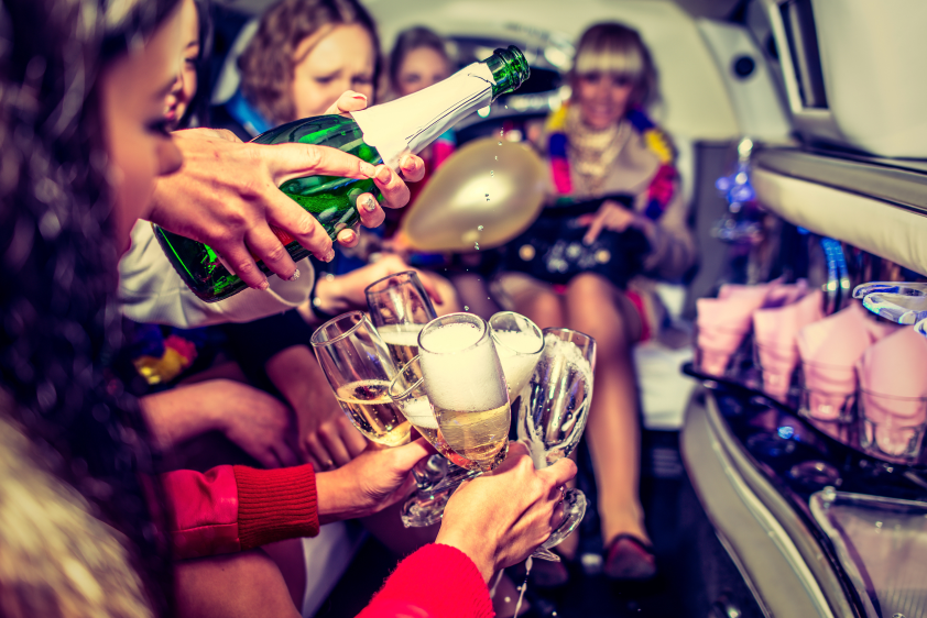 A group of people sitting around drinking champagne.