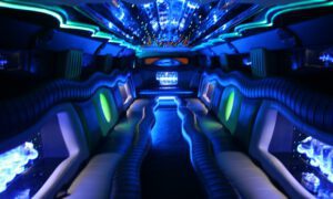 A limo is lit up at night with blue lights.
