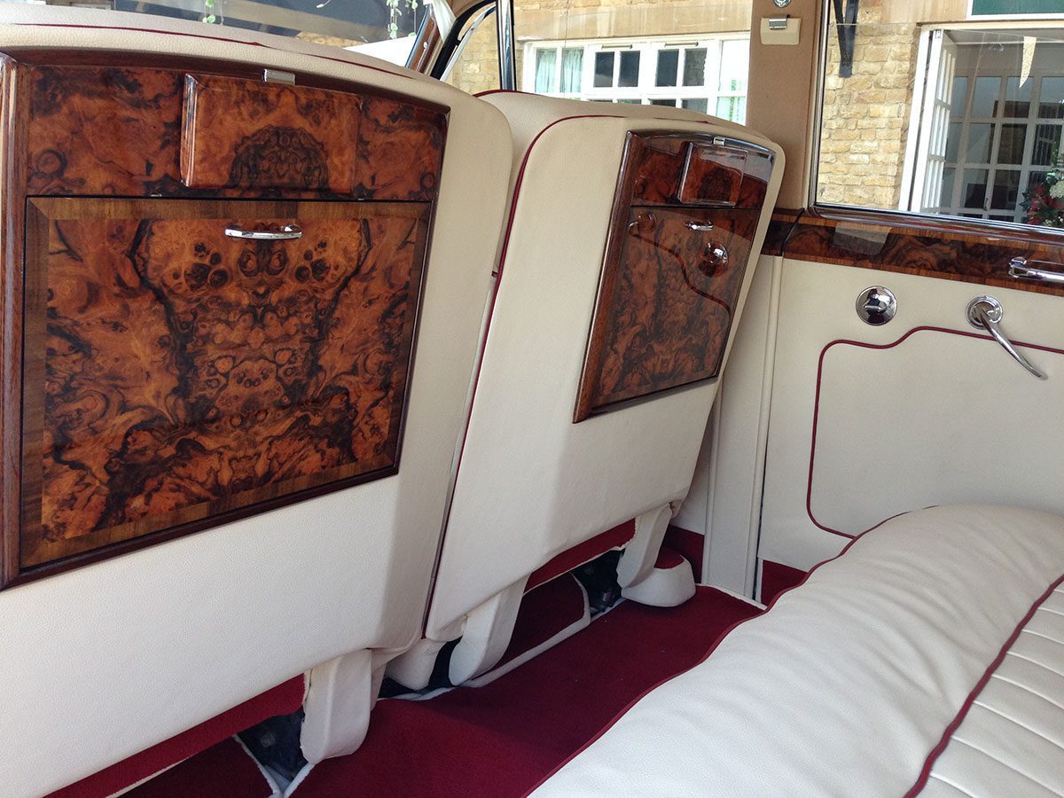 A view of the back seats in an old fashioned car.