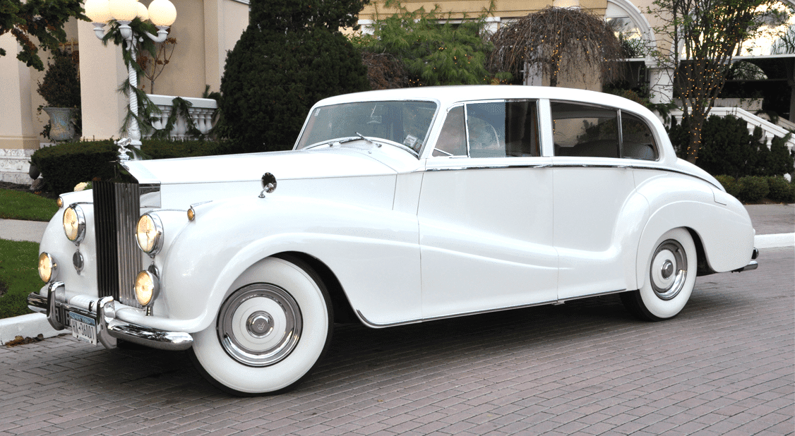 A white car parked on the side of a road.