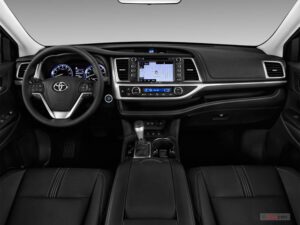 A dashboard and steering wheel of a car.