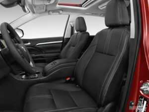 A car with black leather seats and red trim.
