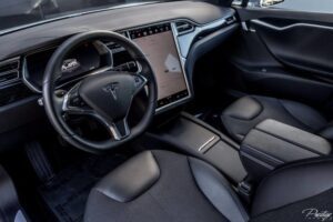 A car with black leather seats and a dashboard.