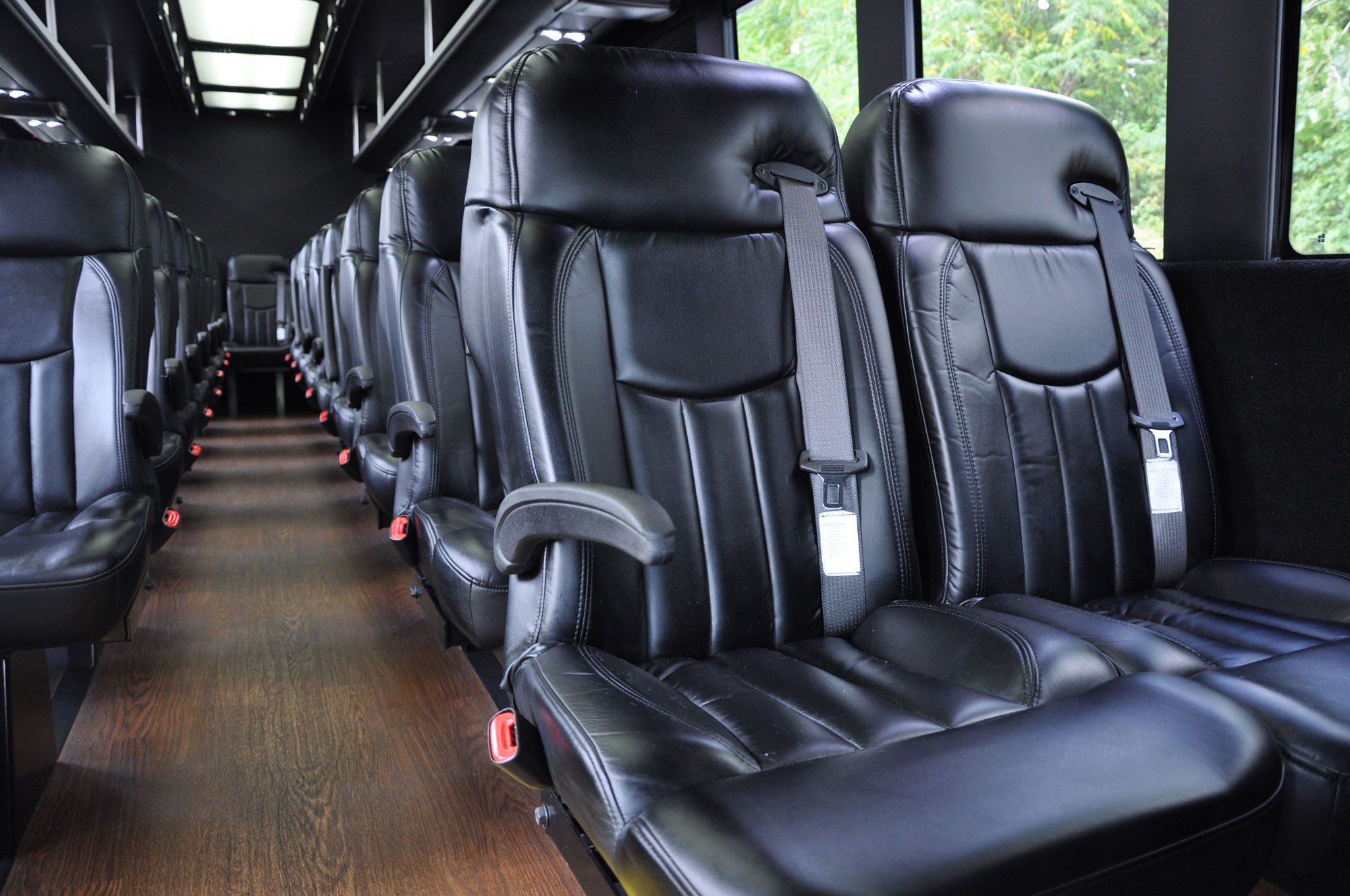 A row of seats in the back of a bus.