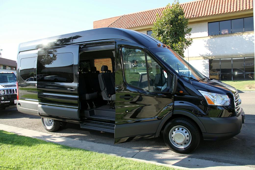 A black van parked in front of a house.