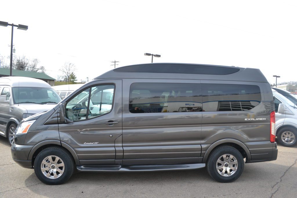 A van parked in the parking lot of a building.