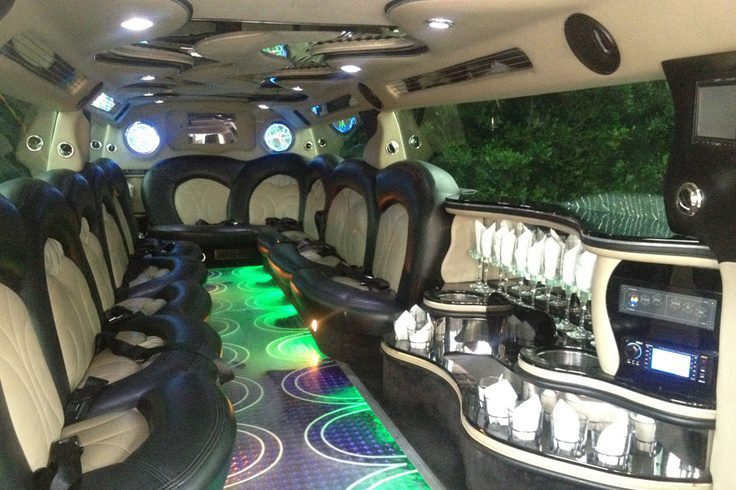 A limo with many seats and lights on the side.