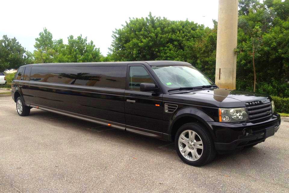 A black limo is parked in the parking lot.