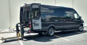 A van with the back door open parked in a parking lot.