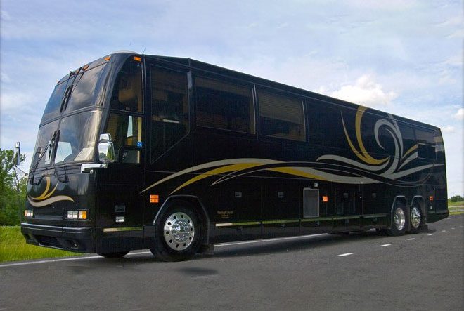 A black and yellow bus is driving down the street