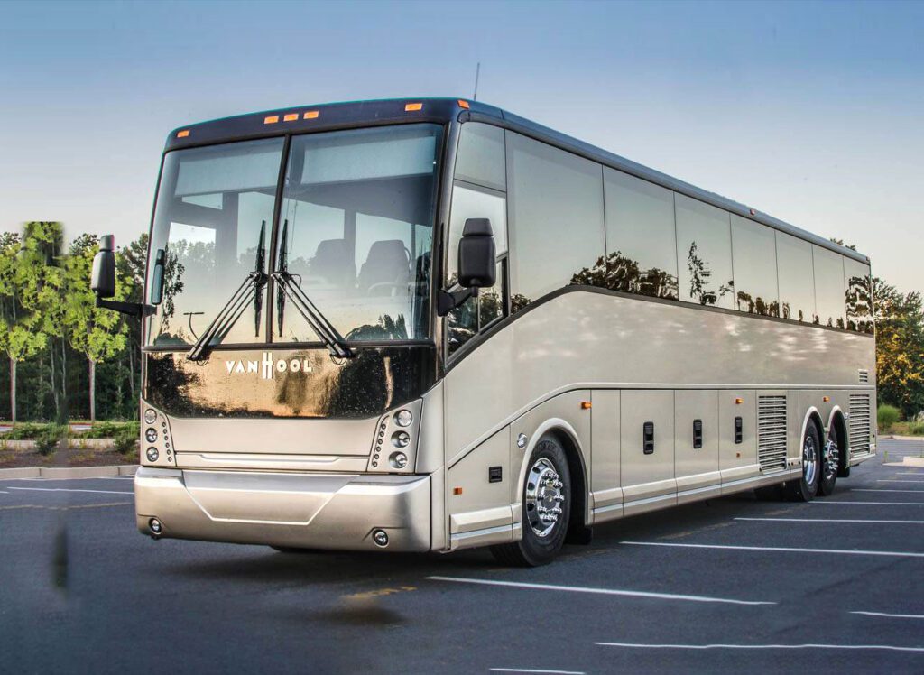 A large white bus driving down the street.