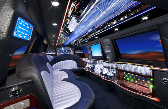 A limo with many seats and two tvs