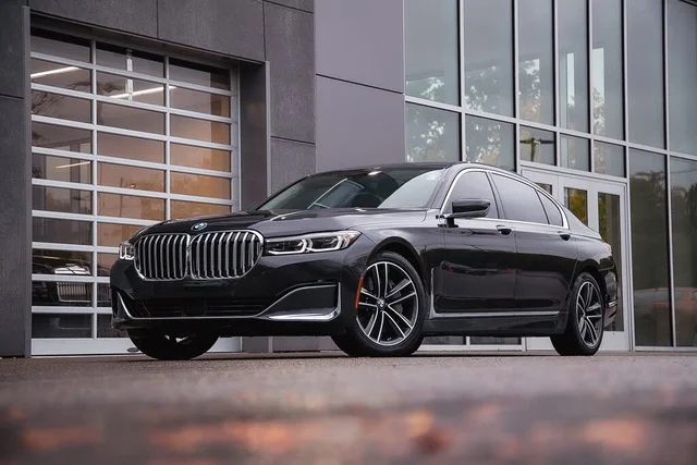 A black bmw parked in front of a building.