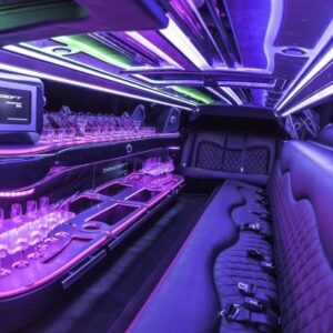 A limo with purple lights and seats in it