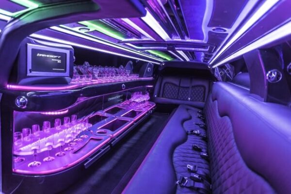 A limo with purple lights and seats in it