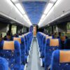 A train car with blue seats and orange trim.