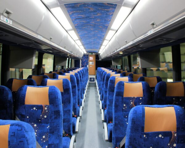 A train car with blue seats and orange trim.