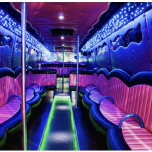 A neon lit party bus with pink and purple seats.