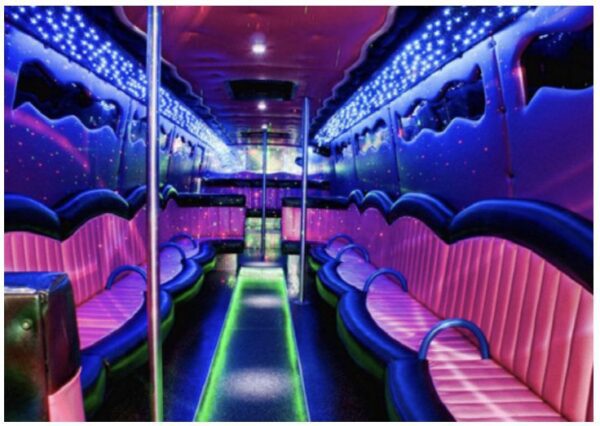 A neon lit party bus with pink and purple seats.