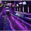 A purple party bus with neon lights and musical instruments.