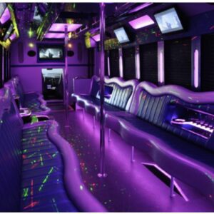 A purple party bus with neon lights and musical instruments.