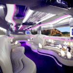 A white limo with purple lights and tables