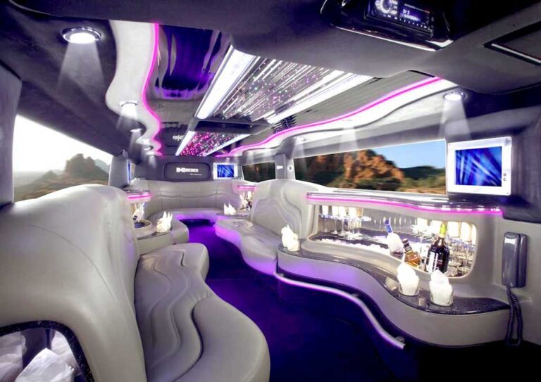 A white limo with purple lights and tables