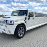 A white limo is parked on the street.