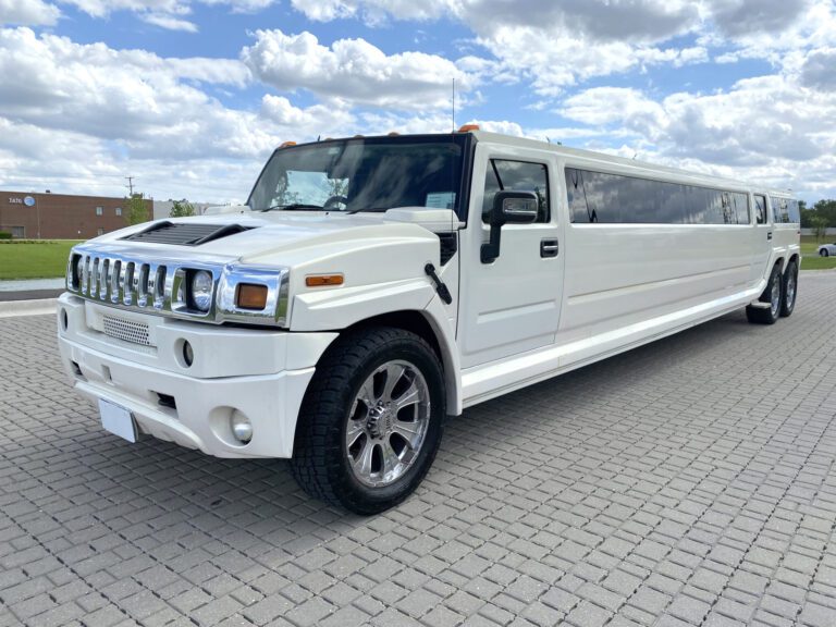 A white limo is parked on the street.