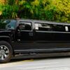 A black limo driving down the street