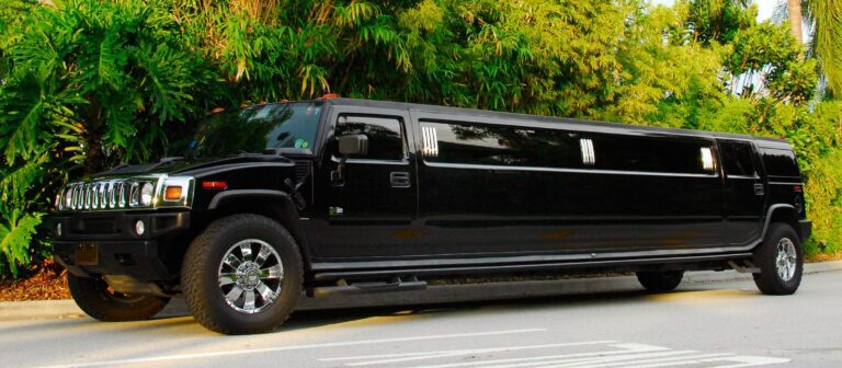 A black limo driving down the street