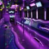 A purple party bus with neon lights and tables.