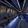 A bus with many seats and lights on the side.